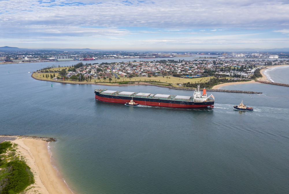 A large transport ship travelling through Newcastle Harbour; grain farmers have been keeping an eye on the Wheat Port Code.